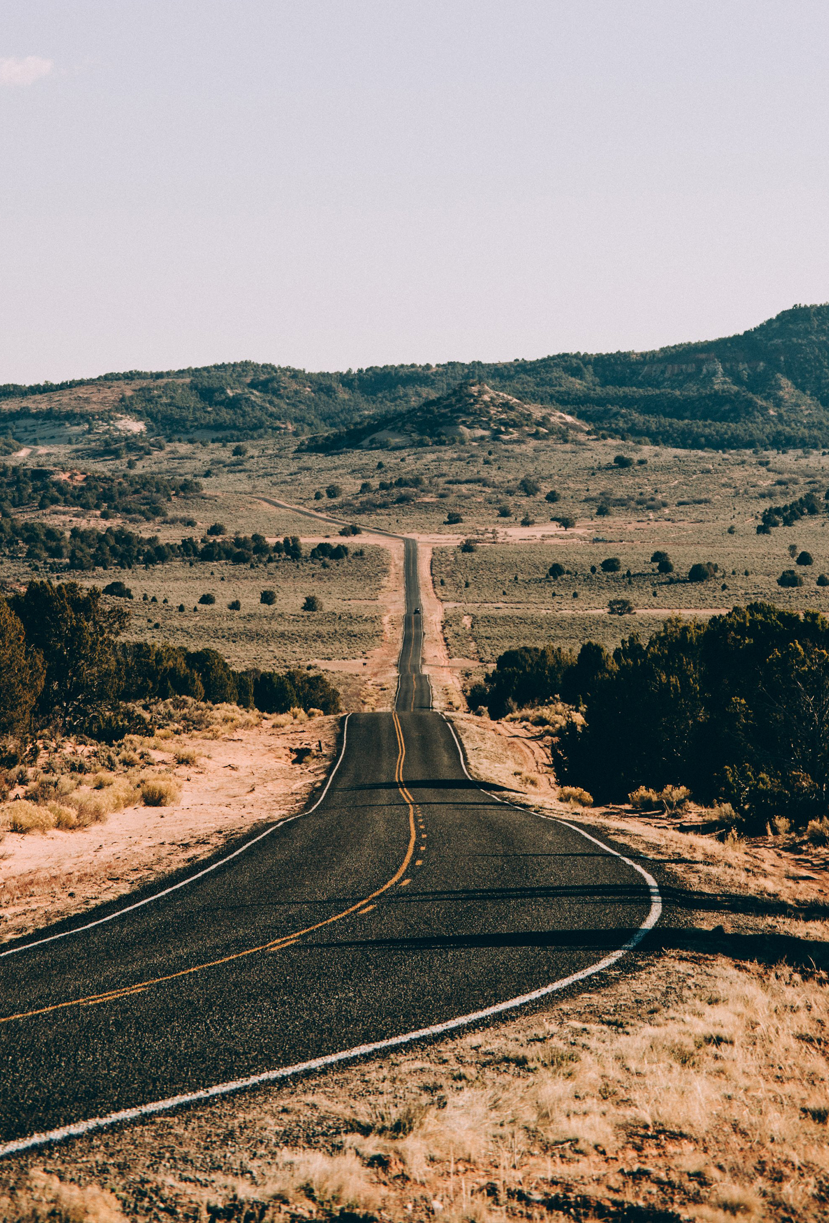 Open road scenic desert highway with mountains in the distance