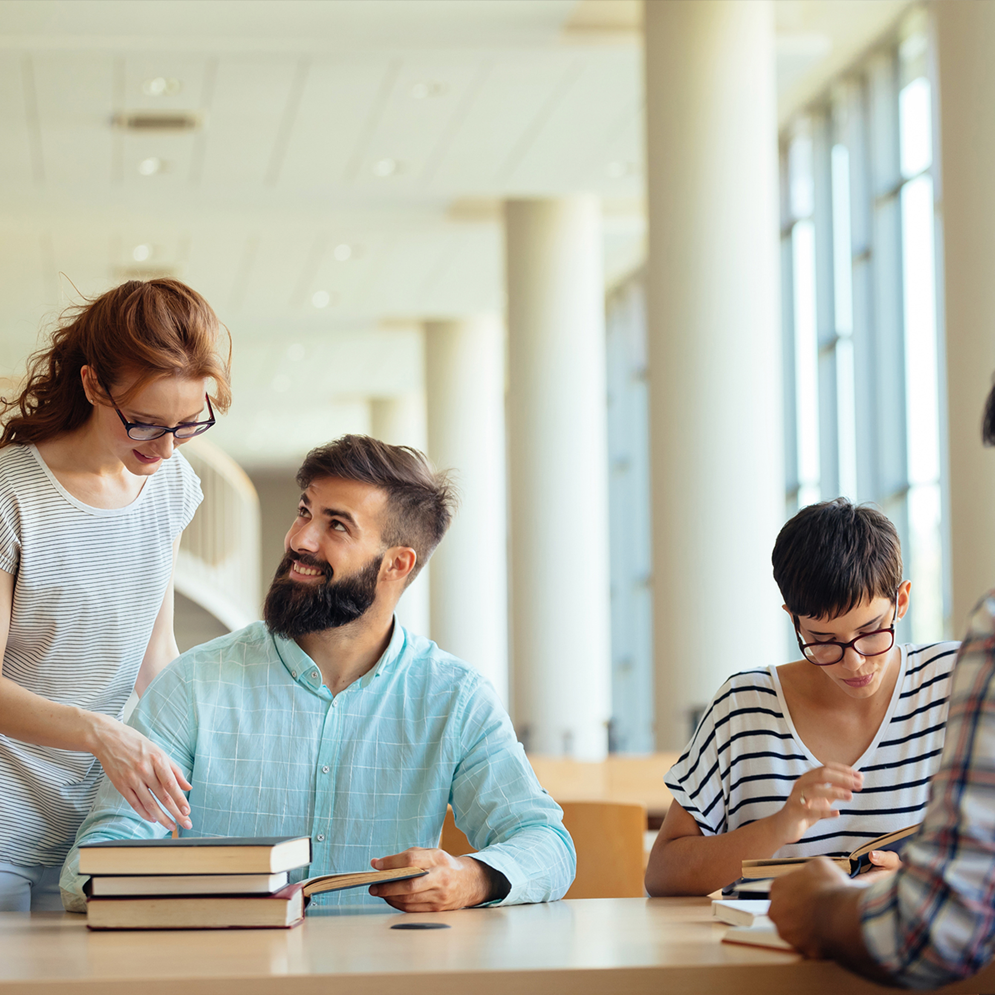 Fun young college students studying in the library