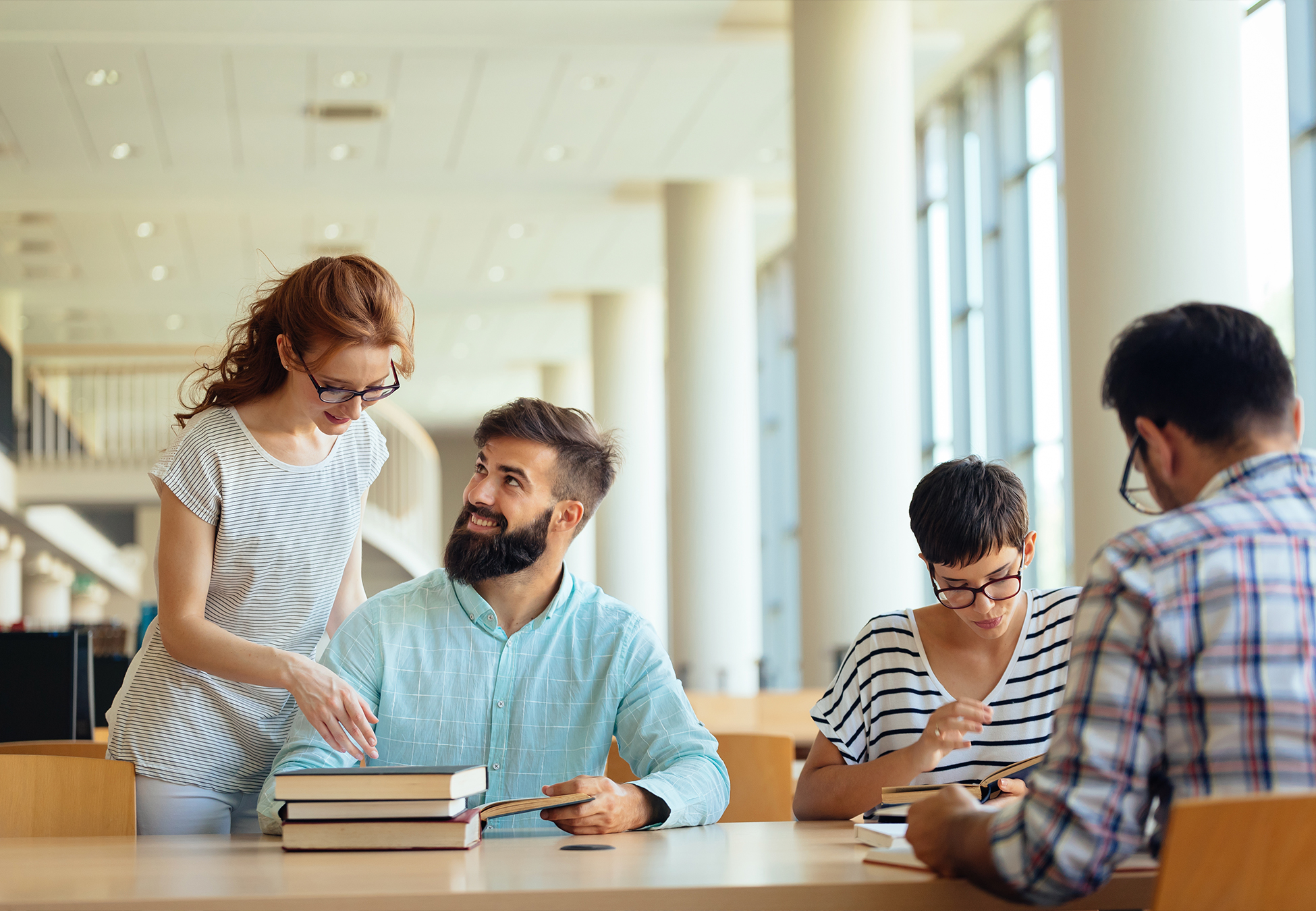 Fun young college students studying in the library